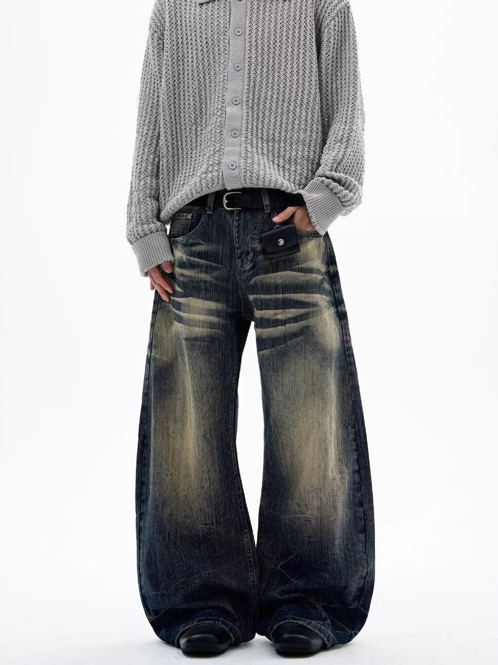 Men's vintage wash wide leg jeans with distressed detailing and a relaxed fit.