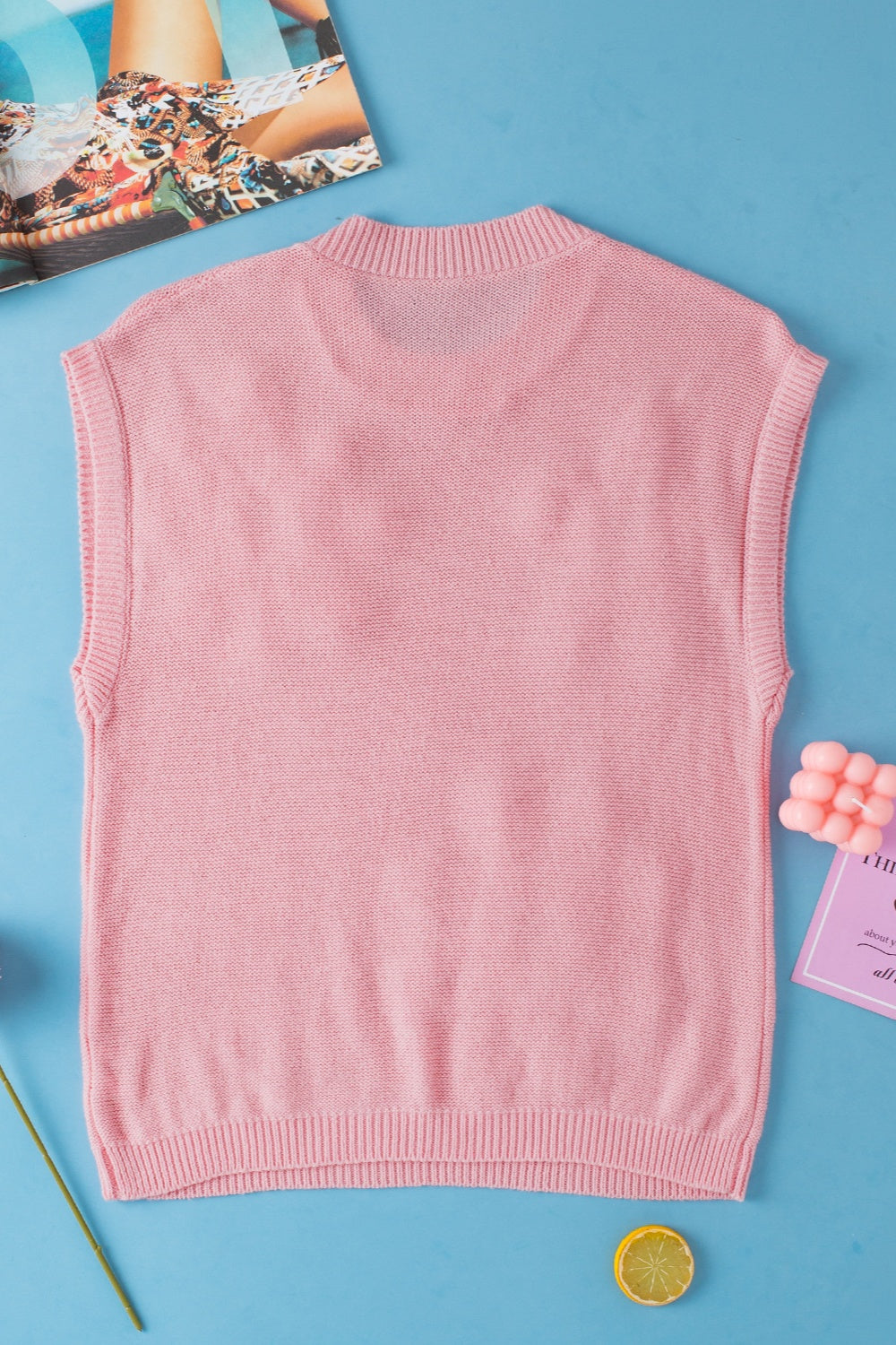 Dusty pink knit sleeveless top with a mock neckline and ribbed hem.