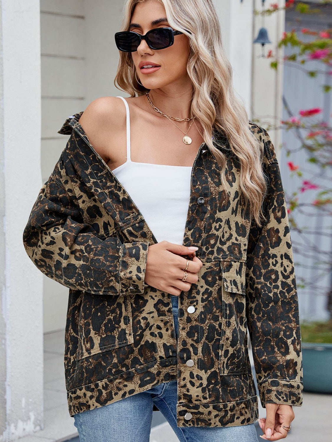 Leopard print utility denim jacket with chest pockets and button front.