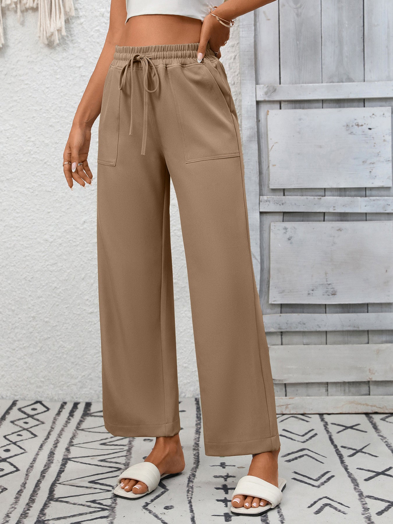 Khaki drawstring wide-leg pants with elastic waistband and pockets.