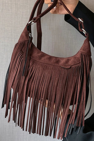 Dark brown suede crescent crossbody bag with long fringe details.