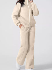 Beige cotton zip-up jacket and drawstring pants set with subtle seam details.