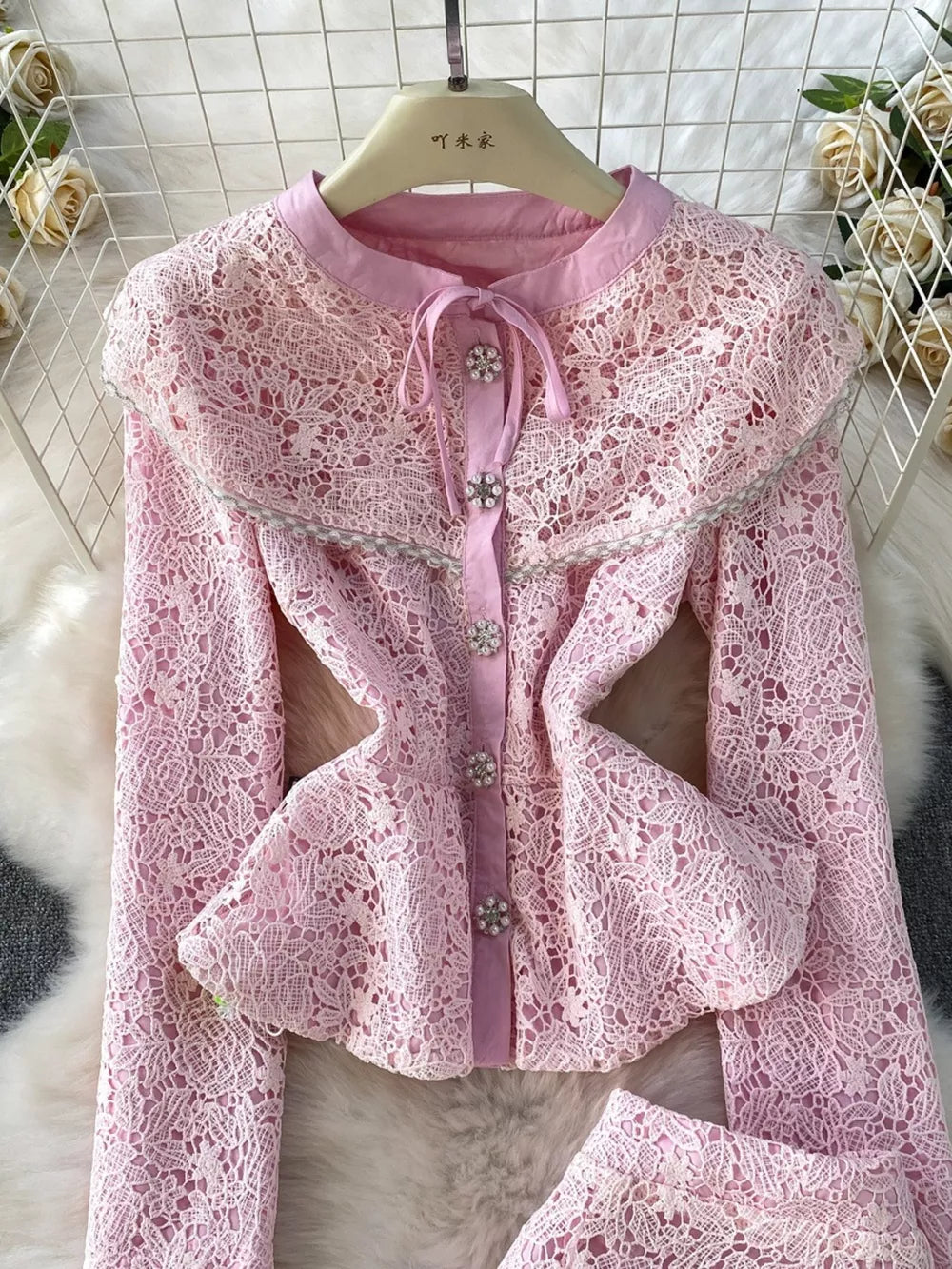Blush pink lace peplum top with a Peter Pan collar and jewel buttons.