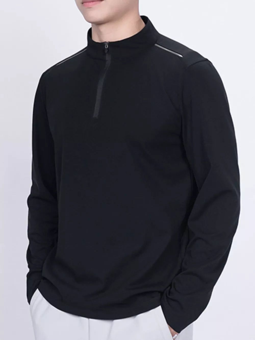 Black long sleeve active t-shirt with quarter zip and reflective shoulder detail.
