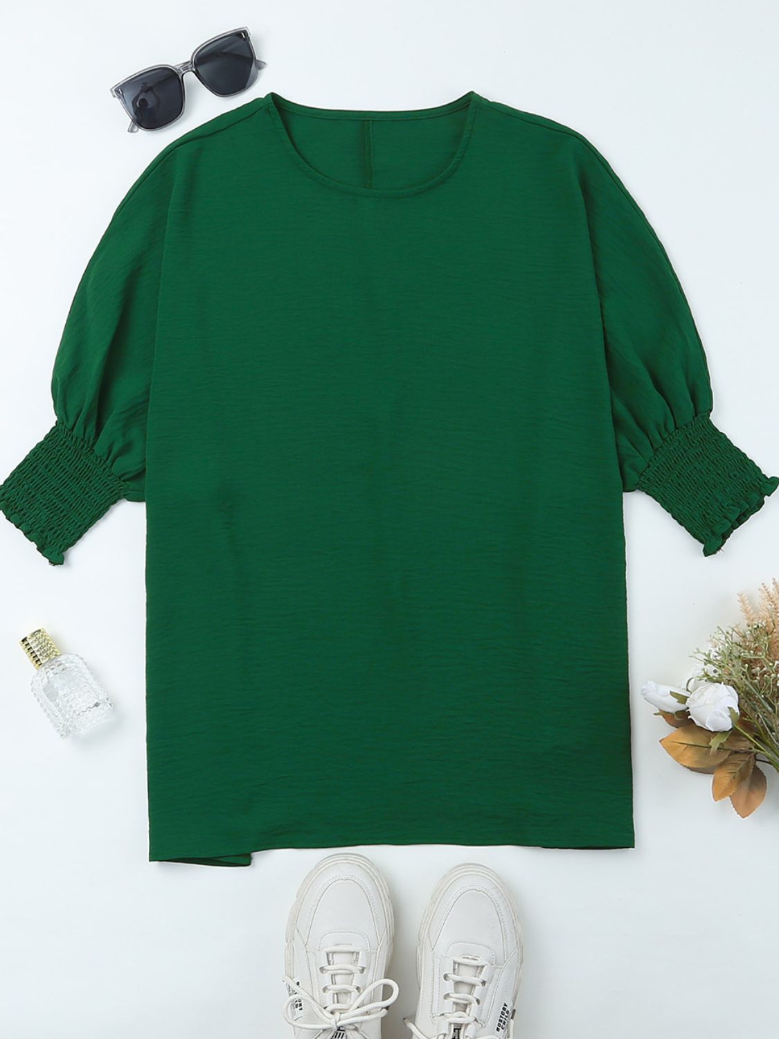 Dark green textured blouse with round neck and elastic cuffs