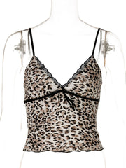 Print lace cami top with leopard pattern, V-neck, adjustable straps, and bow detail.