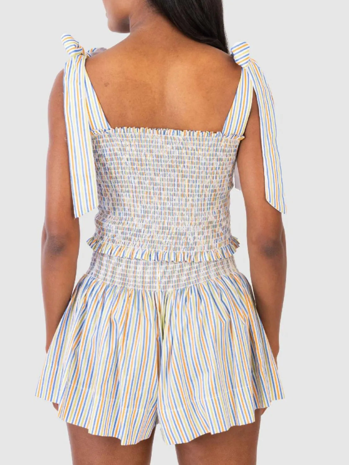 Rainbow striped smocked bodice and shorts set with tie shoulder straps.