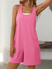 Pink sleeveless utility romper with seam detail and patch pockets.