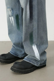 Ink-Blot Wide Leg Denim jeans in medium wash with abstract paint splatters and distressed details.