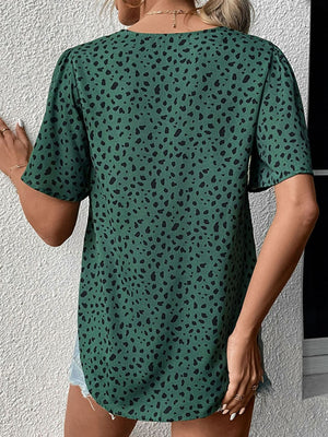 Emerald leopard print V-neck blouse with short sleeves.