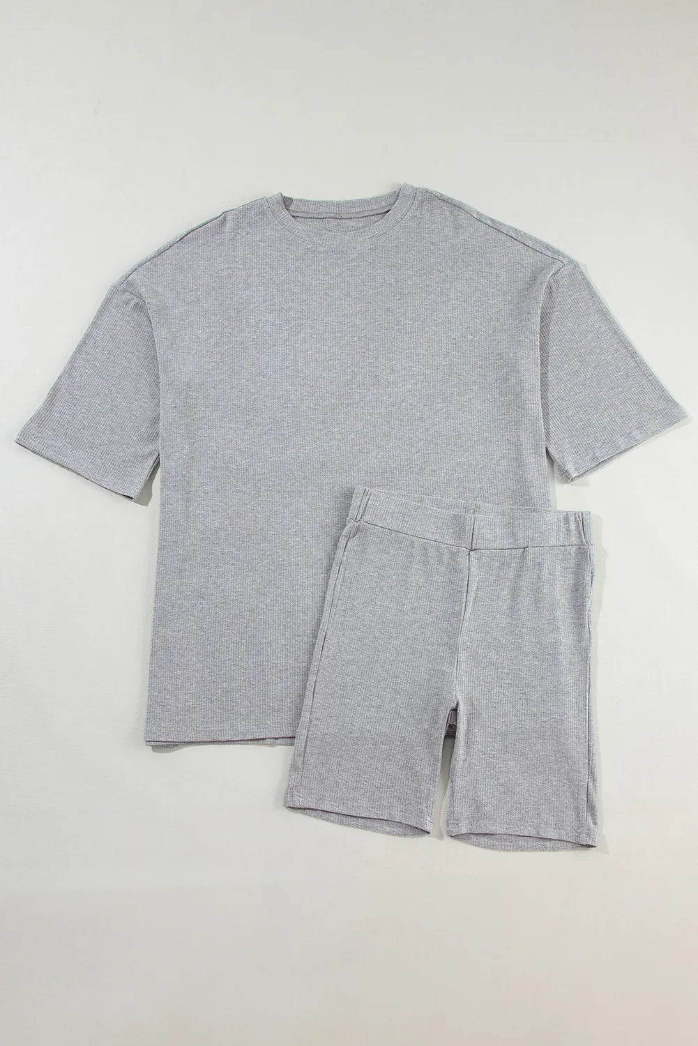 Gray ribbed knit lounge set with relaxed fit t-shirt and biker shorts.