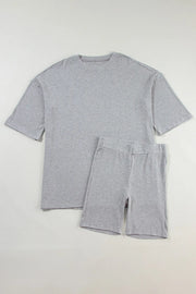 Gray ribbed knit lounge set with relaxed fit t-shirt and biker shorts.