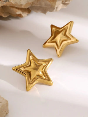 Gold starburst stud earrings with sculpted, layered design.
