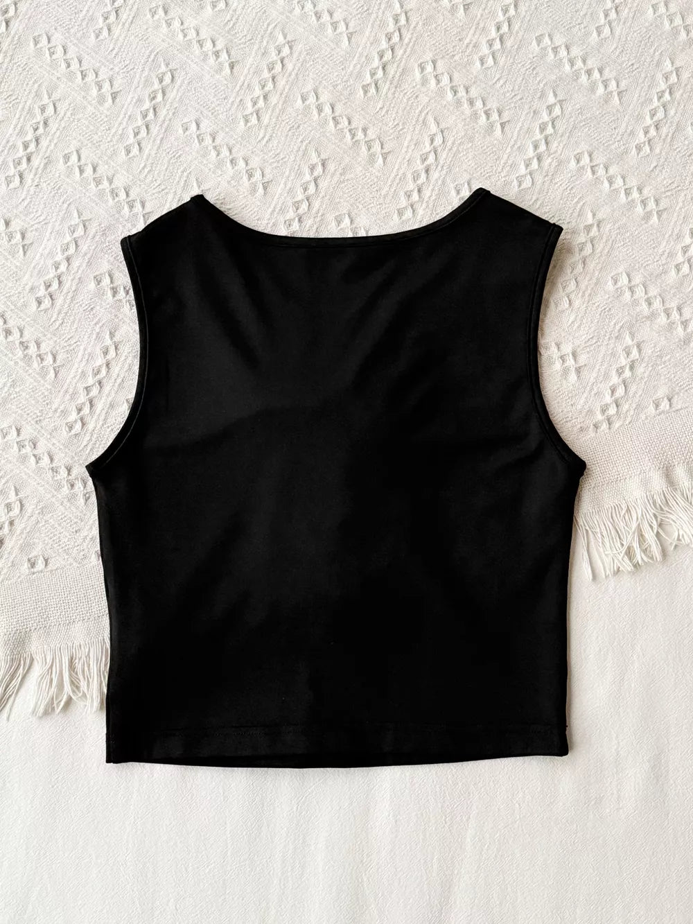 Black crop tank top with round neck and floral applique detail