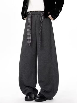 Men's gray relaxed fit wide-leg sweatpants with a plaid tie belt.