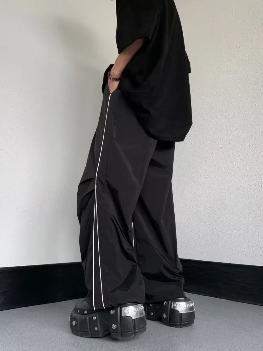 Men's Striped Wide Leg Pants in Black, model styling view
