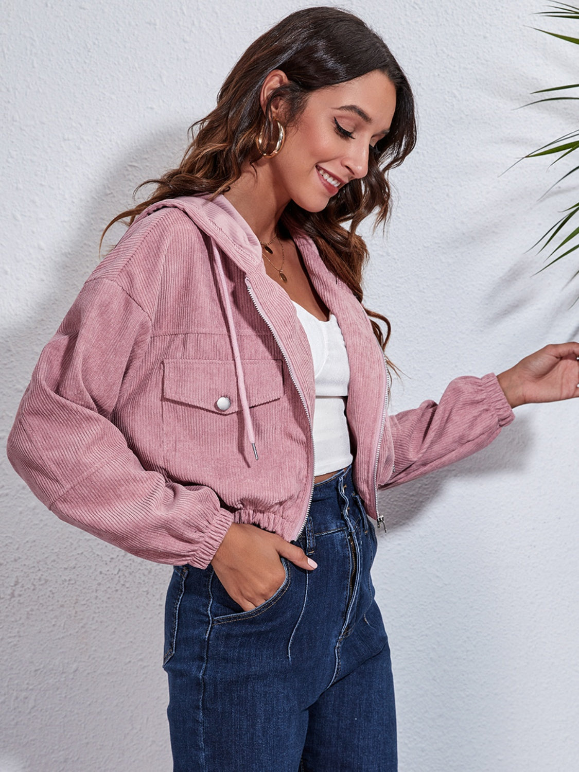 Cropped corduroy hooded jacket in blush pink with zip front and chest pockets.