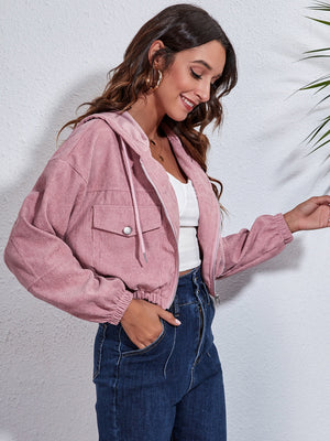 Cropped corduroy hooded jacket in blush pink with zip front and chest pockets.