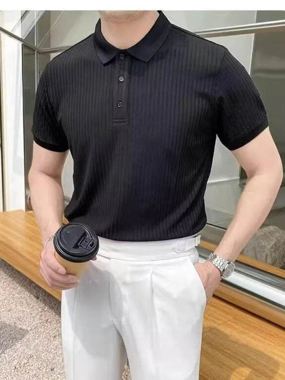 Black ribbed polo shirt with button details and short sleeves.