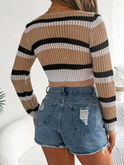 Cropped tan crochet cardigan with black and white stripes, long sleeves, and open knit detail.