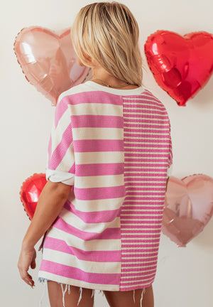 Colorblock stripe waffle knit top in pink and white with crew neck and short sleeves.