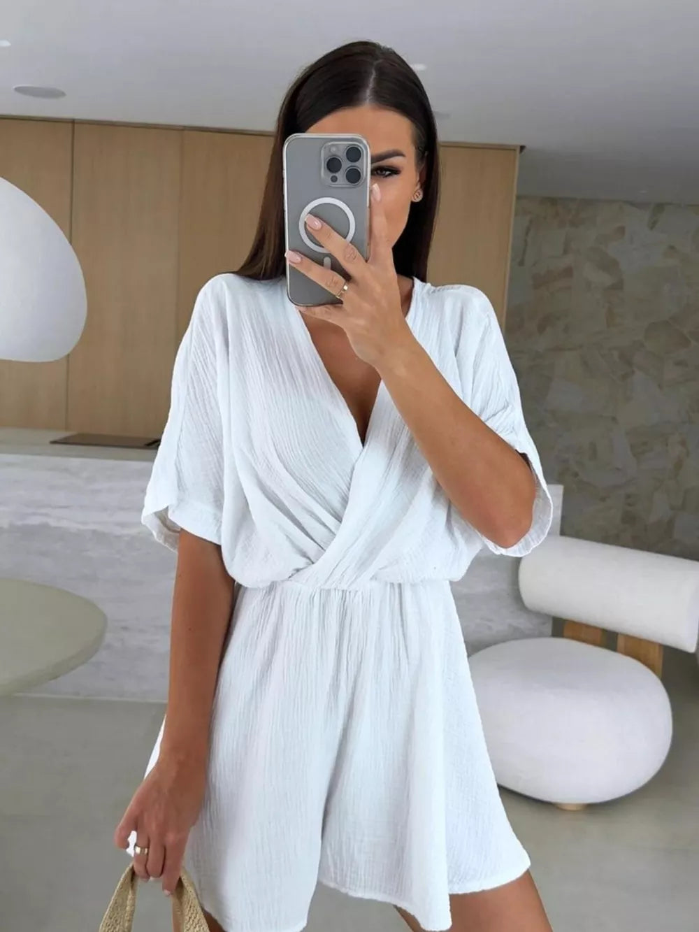 White twist-detail V-neck romper with dolman sleeves and cinched waist.