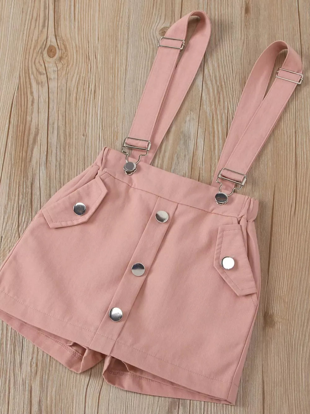 Pink cotton suspender shorts with button front and pocket details