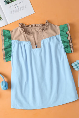 Colorblock ruffle yoke blouse in light blue with tan and green accents.
