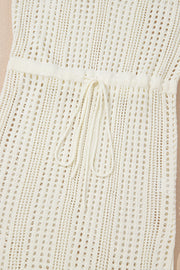 Beige open-knit mini dress with drawstring waist and breathable acrylic fabric.