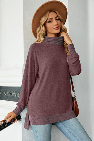 Colorblock raglan turtleneck tunic in heathered plum with contrasting gray neckline and cuffs.