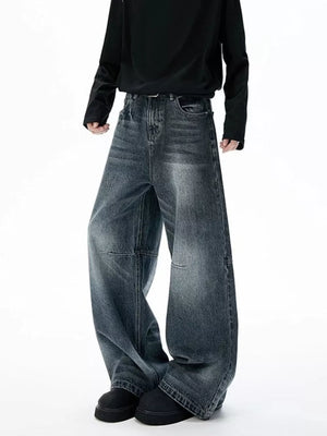 Belted dark-wash wide-leg jeans with unique paneled design and baggy fit.