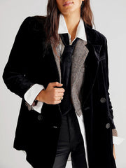 Black velvet double-breasted blazer with patch pockets and button detail.