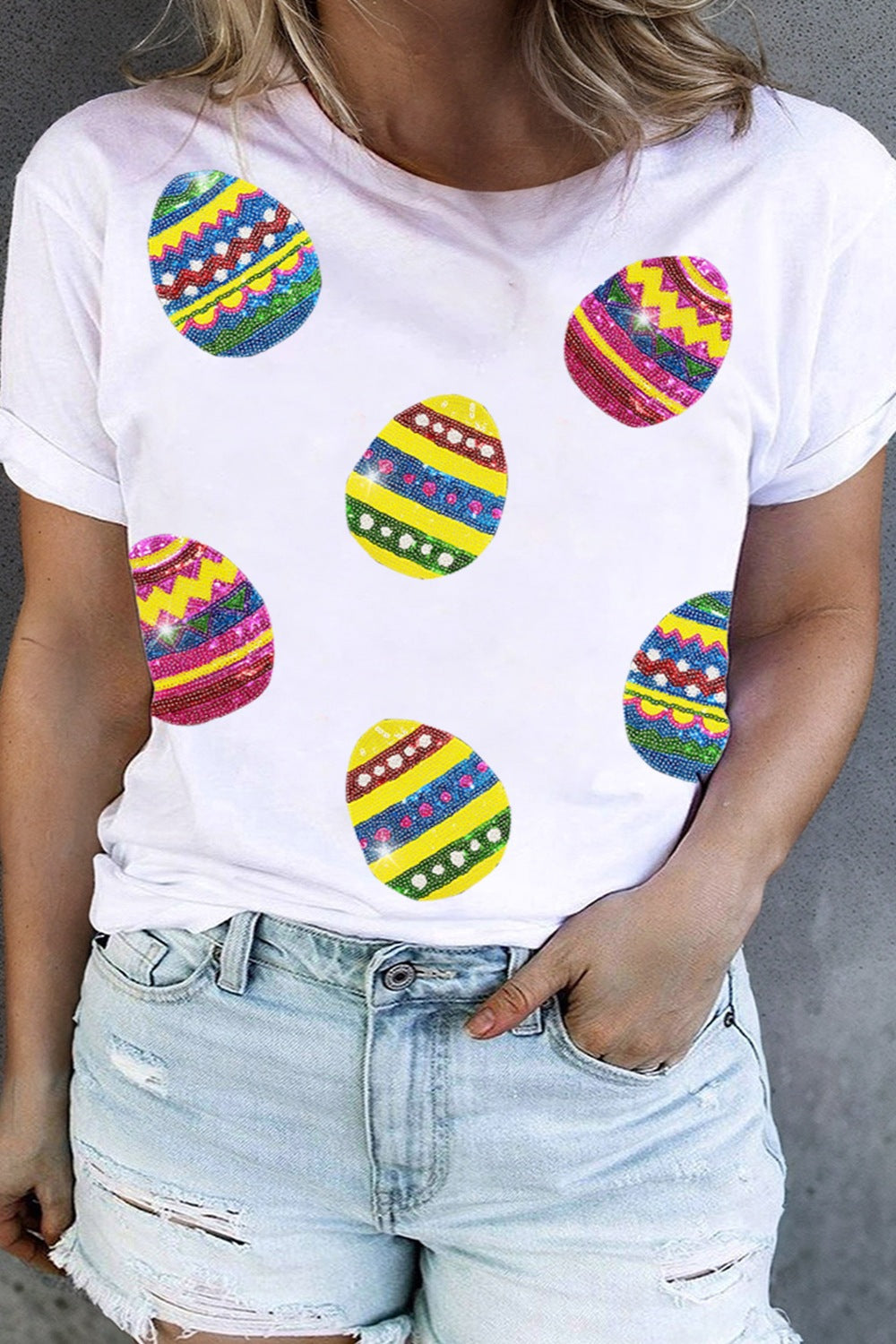 White crewneck tee with scattered sequin Easter egg appliques.