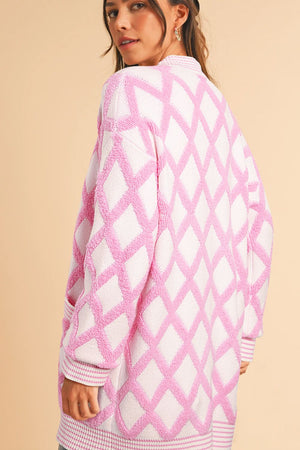 Diamond jacquard knit open cardigan in blush pink with textured diamond pattern and ribbed trim.