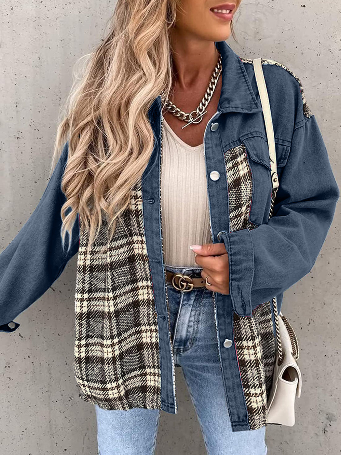 Denim jacket with plaid paneling and button front in light blue.
