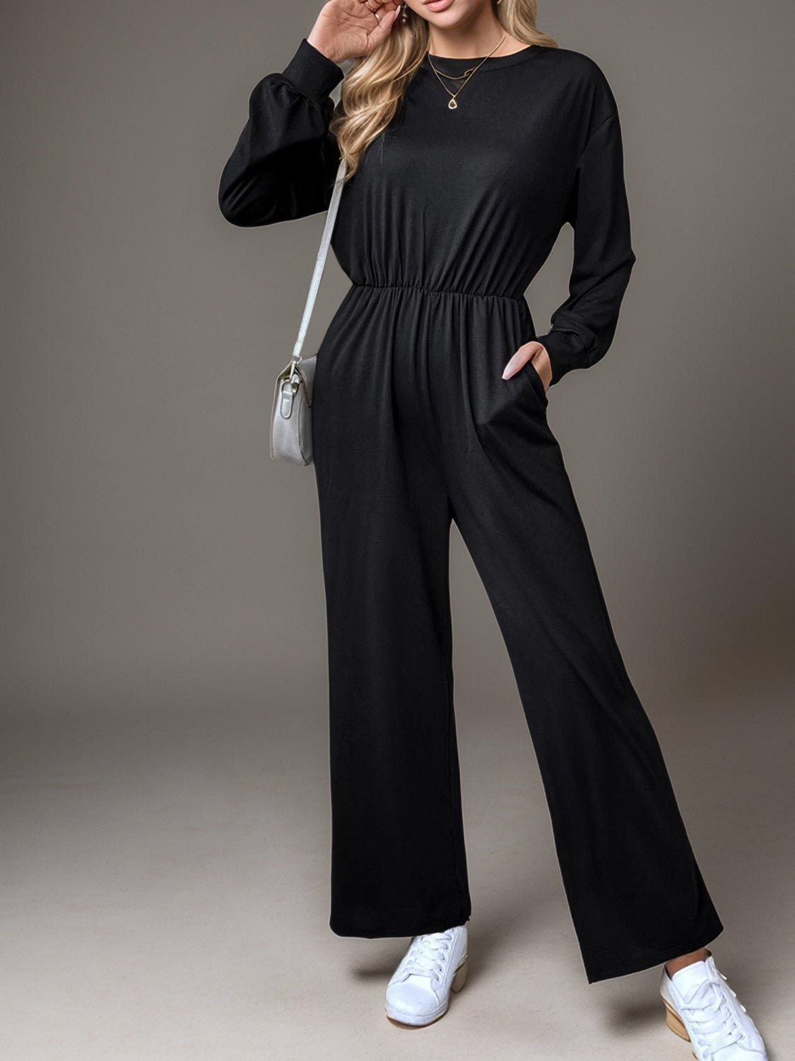 Black long sleeve wide leg jumpsuit with elastic waist and pockets