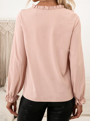 Blush pink blouse with ruffled neckline and blouson sleeves.