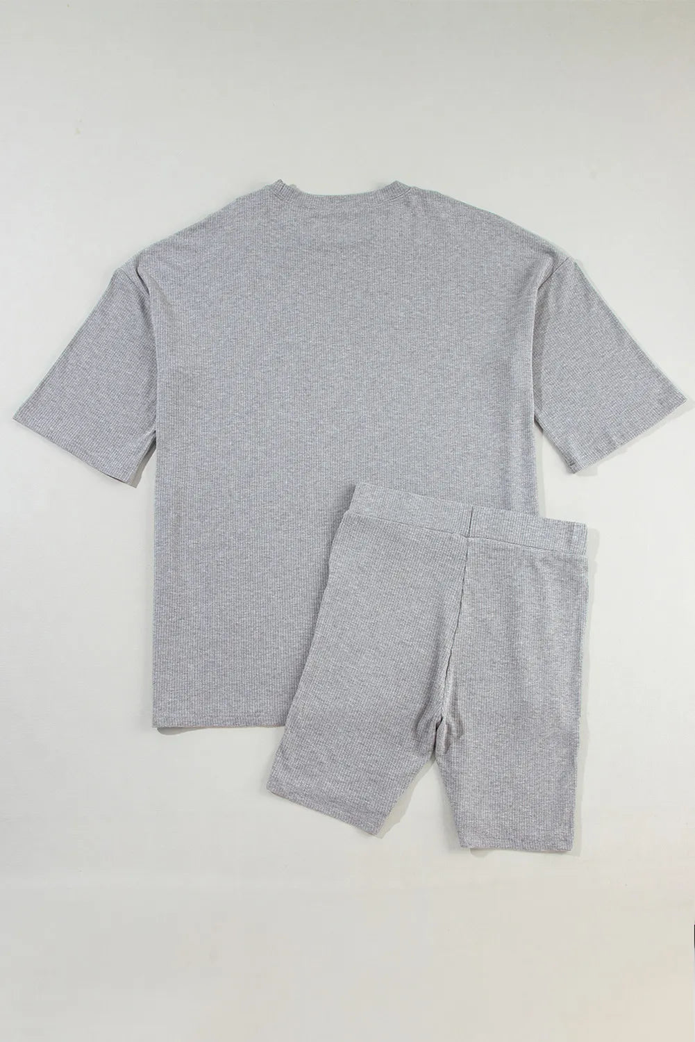 Gray ribbed knit loungewear set with relaxed fit t-shirt and bike shorts.