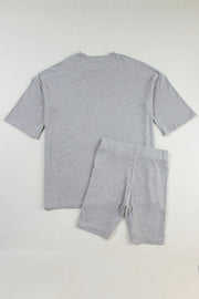 Gray ribbed knit loungewear set with relaxed fit t-shirt and bike shorts.