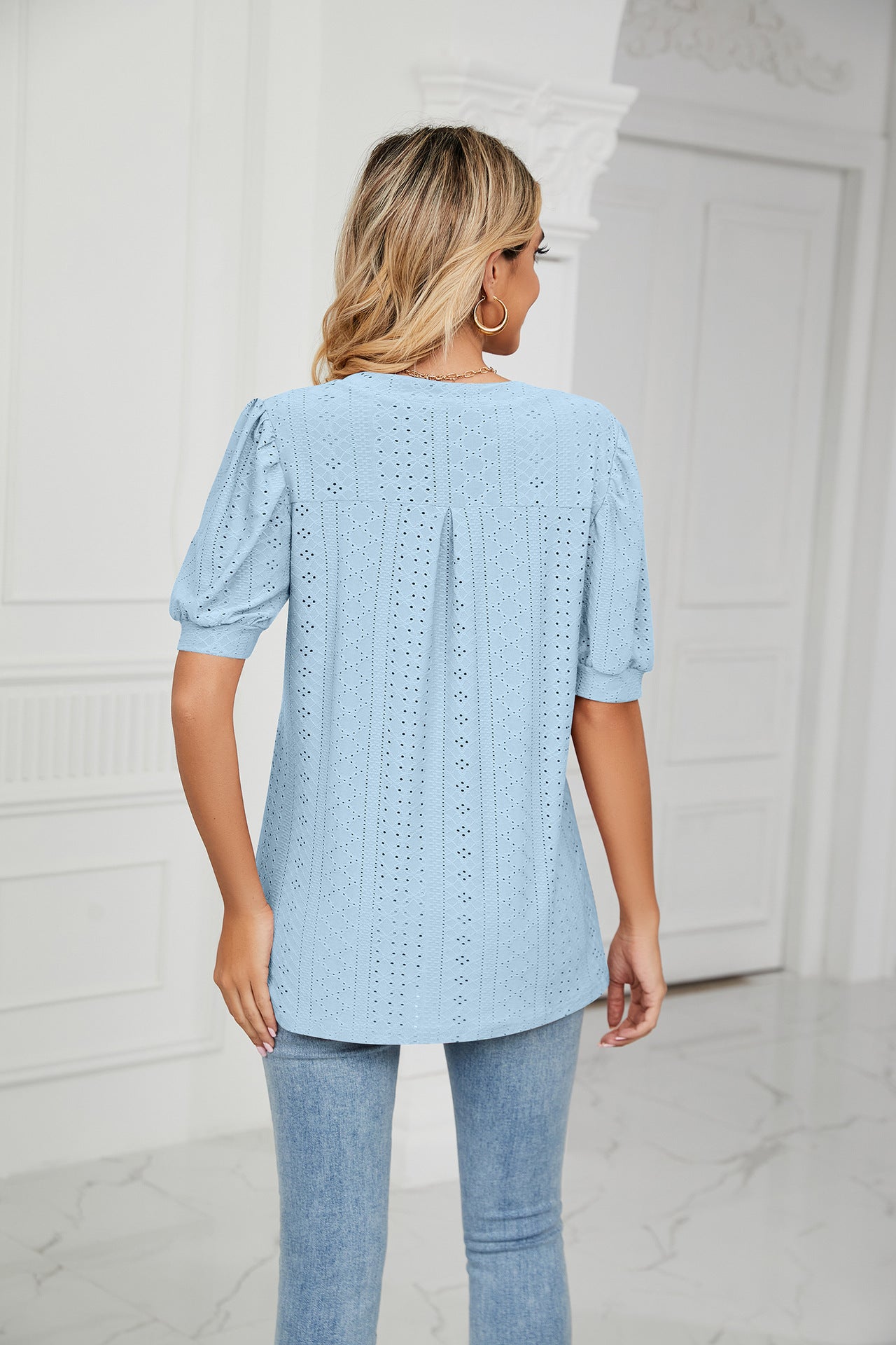 Blue perforated puff sleeve blouse with keyhole detail and eyelet pattern.