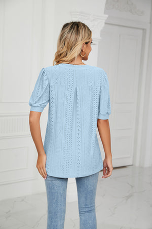 Blue perforated puff sleeve blouse with keyhole detail and eyelet pattern.