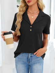 Black waffle knit polo shirt with button placket and collared neckline.