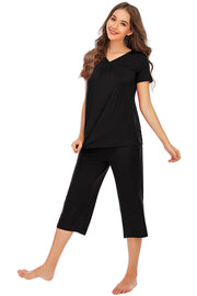 Black loungewear set with gathered V-neck top and capri pants