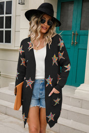 Black knit cardigan with colorful embroidered starbursts, open front, long sleeves, and pockets.