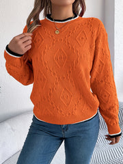 Orange diamond knit sweater with contrast trim neckline and cuffs.