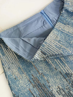 Light blue sequin mini skirt with zipper detail and denim texture.