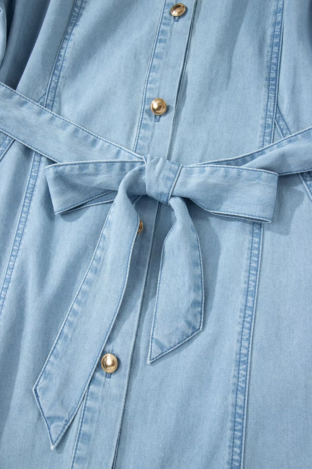 Light blue denim midi dress with button front, belt, and gold buttons.
