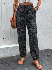Black printed jogger trousers with gathered ankles and pockets
