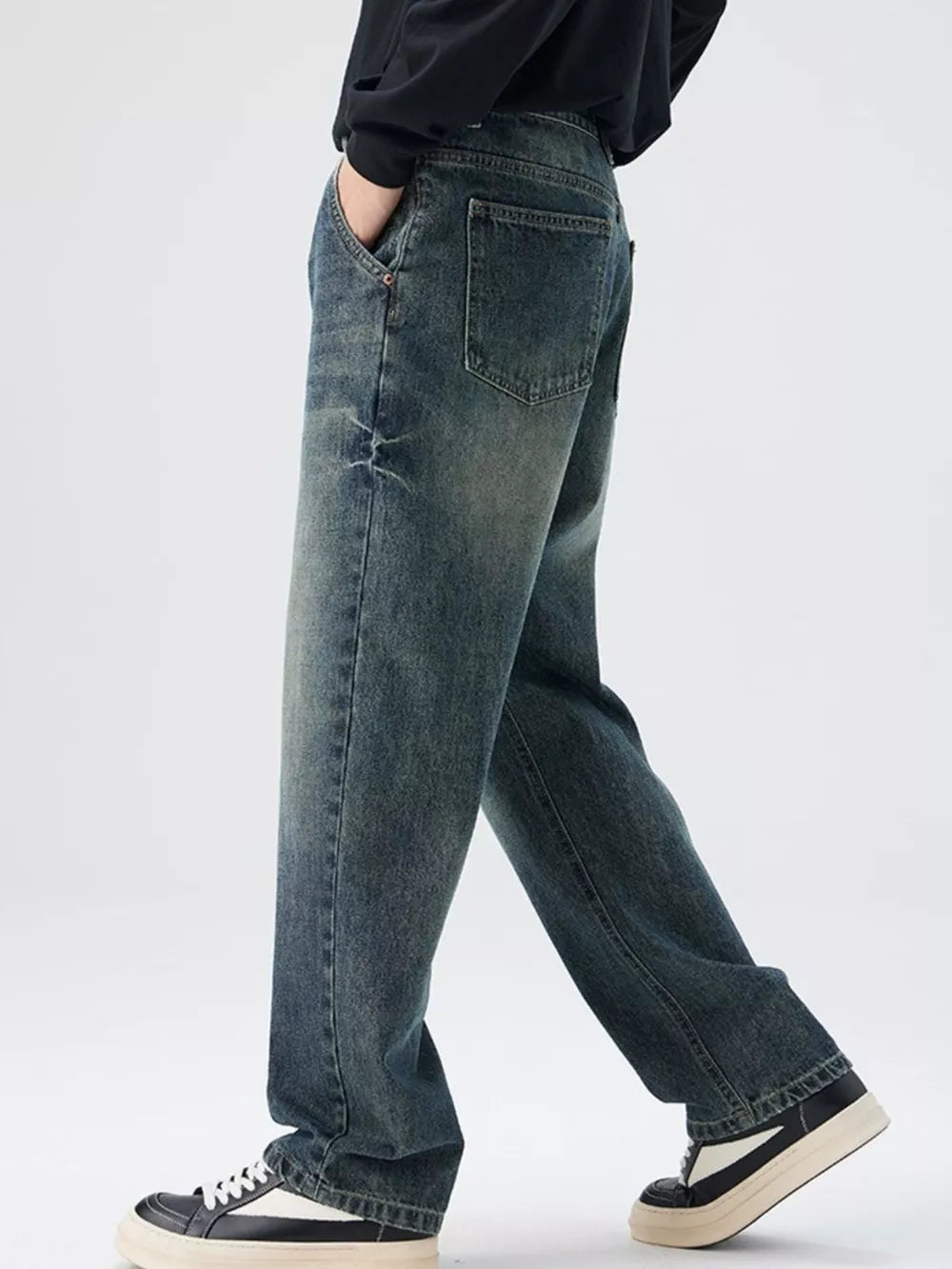 Men's relaxed fit denim jeans in vintage wash with distressed details.