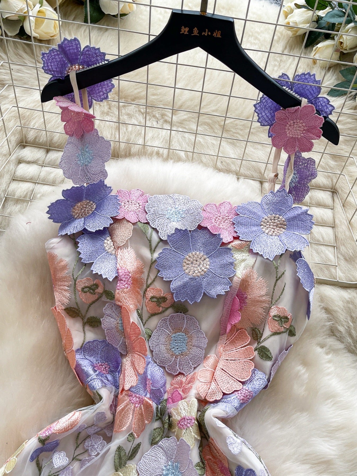 Embroidered floral mini dress with 3D flowers on straps and neckline in pastel colors.